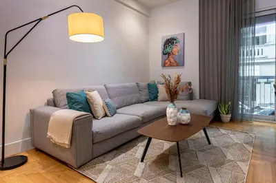 a living room with a couch and a table at Phaedrus Living City Center Lux Flat Kolonaki in Athens