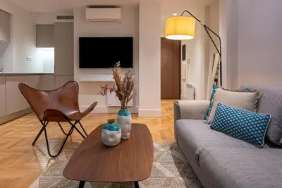a living room with a couch and a table at Phaedrus Living City Center Lux Flat Kolonaki in Athens