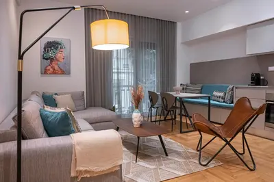 a living room with a couch and a table at Phaedrus Living City Center Lux Flat Kolonaki in Athens