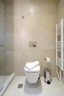 a bathroom with a toilet and a shower at Spacious 3-Bedroom Retreat in the Heart of Pagrati in Athens