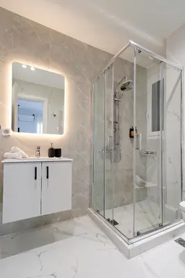 a bathroom with a shower and a sink at Spacious 3-Bedroom Retreat in the Heart of Pagrati in Athens