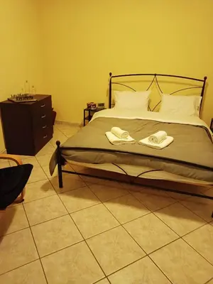 a bedroom with a bed with two towels on it at Detached house with a lovely yard 5' walk from Metro Station Agios Dimitrios and METRO MALL in Athens