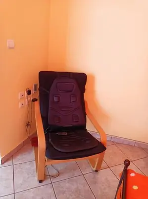 a bag sitting on a chair in a room at Detached house with a lovely yard 5' walk from Metro Station Agios Dimitrios and METRO MALL in Athens