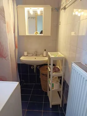 a small bathroom with a sink and a mirror at Detached house with a lovely yard 5' walk from Metro Station Agios Dimitrios and METRO MALL in Athens