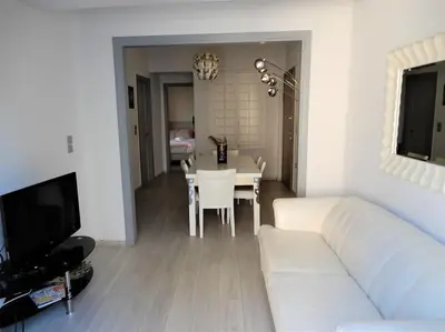 a living room with a white couch and a table at A-07! 2' walk 2 Acropolis Museum! 2BR-Sunny terrace! Extra fees for 2nd room in Athens