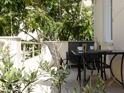 a black table and chairs sitting on a patio at A-07! 2' walk 2 Acropolis Museum! 2BR-Sunny terrace! Extra fees for 2nd room in Athens