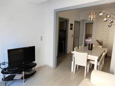 a living room with a dining table and a television at A-07! 2' walk 2 Acropolis Museum! 2BR-Sunny terrace! Extra fees for 2nd room in Athens