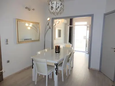 a white dining room with a white table and chairs at A-07! 2' walk 2 Acropolis Museum! 2BR-Sunny terrace! Extra fees for 2nd room in Athens