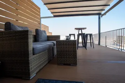 a patio with two chairs and a table on a balcony at Athens Skyline Loft in Athens
