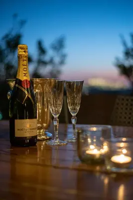 a bottle of wine sitting on a table with glasses at Athens Skyline Loft in Athens