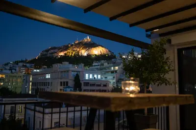 a view of a mountain at night from a balcony at Athens Skyline Loft in Athens