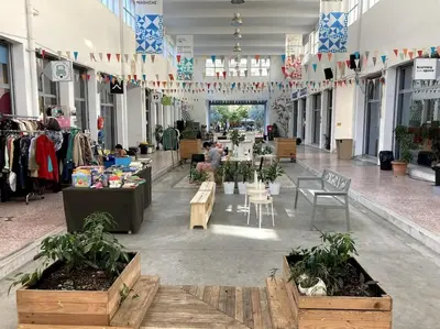 a large room with tables and chairs in a store at Sunny calm apartment in pedestrian street in Athens