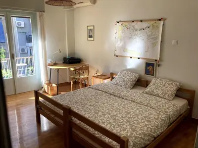 a bedroom with a bed and a map on the wall at Sunny calm apartment in pedestrian street in Athens