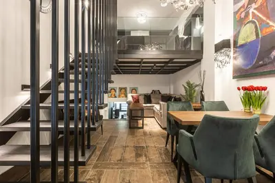 a dining room with a staircase and a table and chairs at BookRoom in Athens