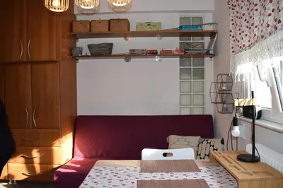 a living room with a red couch and a table at h2h Chris # Μικρό, φωτεινό & βολικό σπίτι in Athens