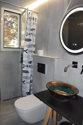 a bathroom with a sink and a toilet and a mirror at h2h Chris # Μικρό, φωτεινό & βολικό σπίτι in Athens