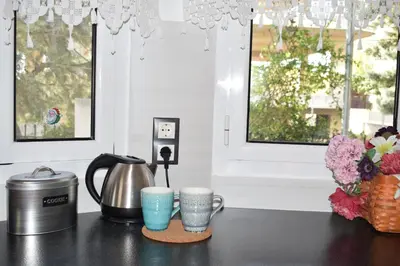 a counter with two coffee cups and a tea kettle at h2h Chris # Μικρό, φωτεινό & βολικό σπίτι in Athens
