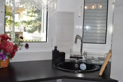 a kitchen counter with a sink and a window at h2h Chris # Μικρό, φωτεινό & βολικό σπίτι in Athens