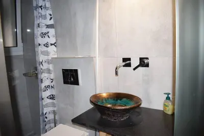 a bathroom with a copper sink and a shower at h2h Chris # Μικρό, φωτεινό & βολικό σπίτι in Athens