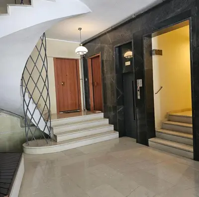 a hallway with stairs and doors in a building at Diocharous garden apartment in Athens