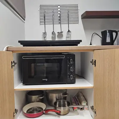 a microwave oven sitting on top of a kitchen counter at Diocharous garden apartment in Athens