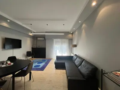 a living room with a couch and a table at Diocharous garden apartment in Athens