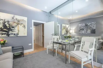 a dining room with a glass table and white chairs at Charming apartment in Kolonaki, Peridot - Homes in Athens