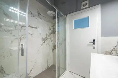 a shower with a glass door in a bathroom at Charming apartment in Kolonaki, Peridot - Homes in Athens