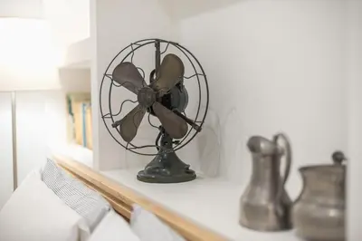 a black fan on a shelf in a room at Charming apartment in Kolonaki, Peridot - Homes in Athens
