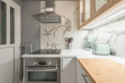 a kitchen with a sink and a stove top oven at Charming apartment in Kolonaki, Peridot - Homes in Athens