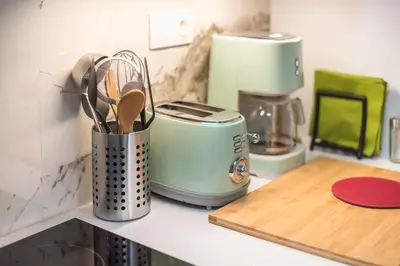 a kitchen counter with a toaster and utensils at Luxurious apartment in Kolonaki, Peridot -Homes in Athens
