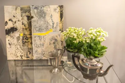 a glass table with two vases of flowers and a painting at Luxurious apartment in Kolonaki, Peridot -Homes in Athens