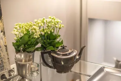 a vase with flowers in it sitting on a sink at Luxurious apartment in Kolonaki, Peridot -Homes in Athens