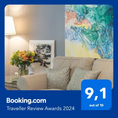 a living room with a couch and a vase of flowers at Luxurious apartment in Kolonaki, Peridot -Homes in Athens