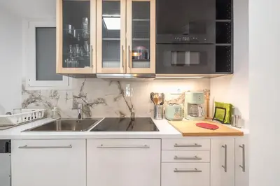 a kitchen with white cabinets and a sink at Luxurious apartment in Kolonaki, Peridot -Homes in Athens