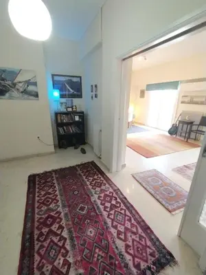 a living room with a red rug on the floor at SAILORS LUXURY APPARTMENT 130m2 in Athens