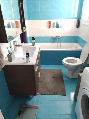 a blue bathroom with a sink and a toilet at SAILORS LUXURY APPARTMENT 130m2 in Athens