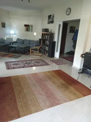a living room with a couch and a table at SAILORS LUXURY APPARTMENT 130m2 in Athens