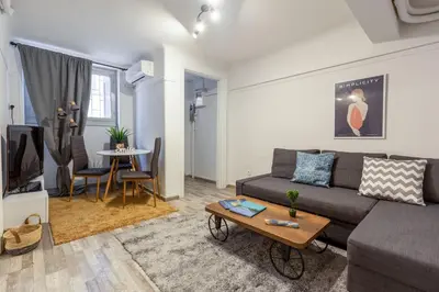 a living room with a couch and a table at Central apartment in the heart of Historic Center in Athens