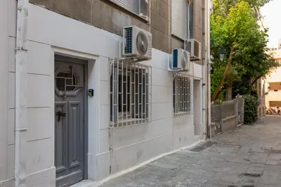 an alley with a door on a building at Central apartment in the heart of Historic Center in Athens