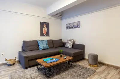 a living room with a couch and a table at Central apartment in the heart of Historic Center in Athens