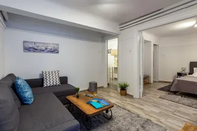 a living room with a couch and a table at Central apartment in the heart of Historic Center in Athens