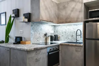 a kitchen with stainless steel appliances and a counter top at apt Seventeen_2-bedroom flat_Athens citycentre in Athens