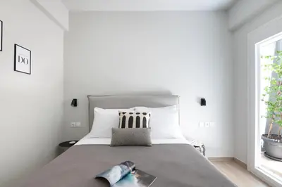 a bedroom with a bed with a book on it at apt Seventeen_2-bedroom flat_Athens citycentre in Athens