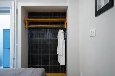 a white dress hanging on a rack in a bedroom at apt Seventeen_2-bedroom flat_Athens citycentre in Athens