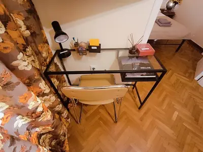 a desk with a chair and a desk with a lamp at Sweet home in Athens in Athens