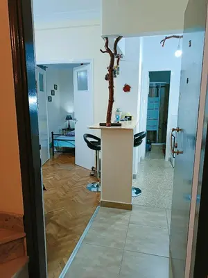 a room with a table and a tree in it at Sweet home in Athens in Athens