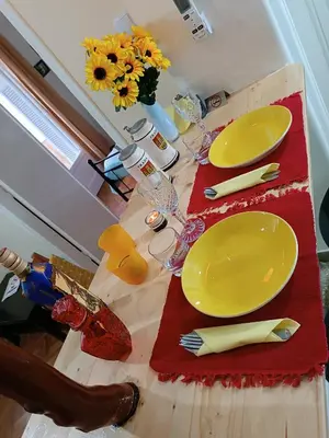 a wooden table with yellow plates and napkins on it at Sweet home in Athens in Athens