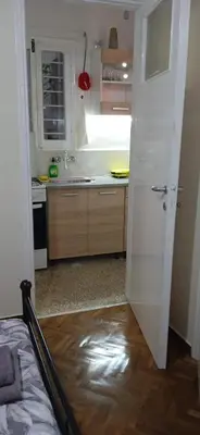 a white kitchen with a sink and a counter at Sweet home in Athens in Athens