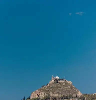 a castle on top of a hill with a blue sky at Acropolis Views Studio in Athens